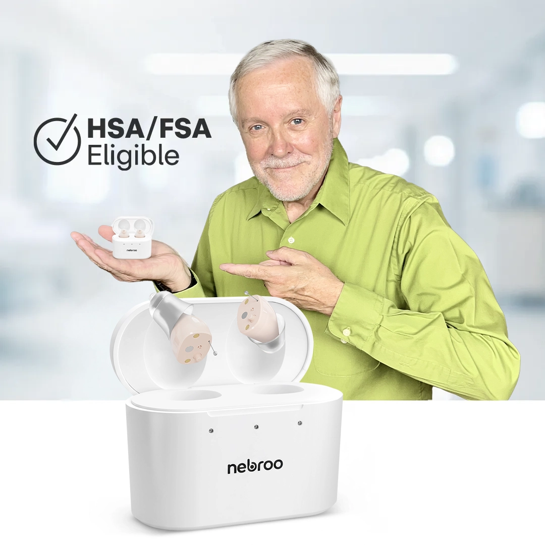 Smiling older man holding a HearWell by Nebroo charging case with two nearly invisible hearing aids — HSA/FSA eligible